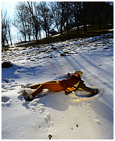 Peeing her pants making snow angels