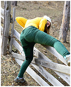 gemma climbs fence pees green jeans 05