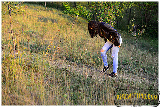 Young girl wets her jeans walking up the trail jeans 