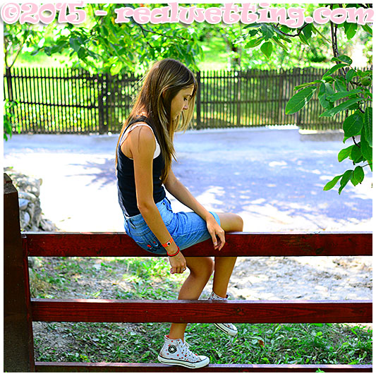 beatrice wets her jeans shorts climbing a fence