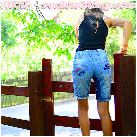 beatrice wets her jeans shorts climbing a fence
