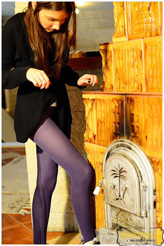 Beatrice feeds the fireplace in purple pantyhose
