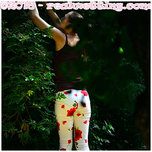 Claudia wets her flowery pants in the orchard