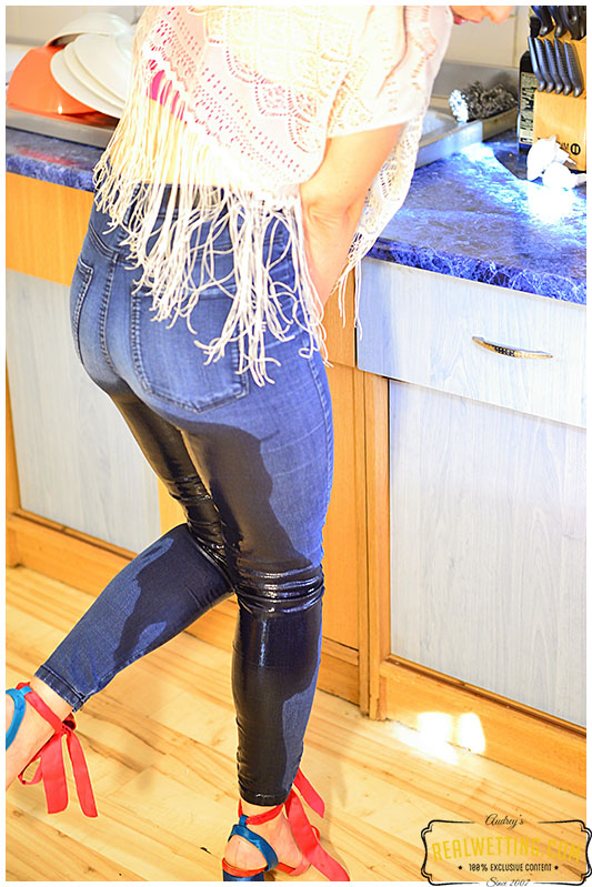 Wetting her jeans while doing the dishes