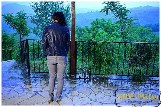 girl wets gray jeans during rain storm