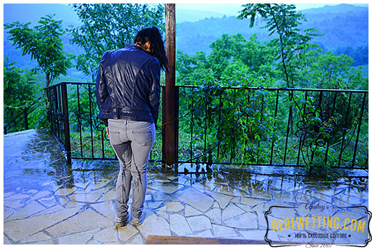 girl wets gray jeans during rain storm