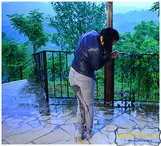 girl wets gray jeans during rain storm