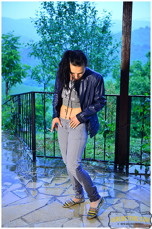 girl wets gray jeans during rain storm