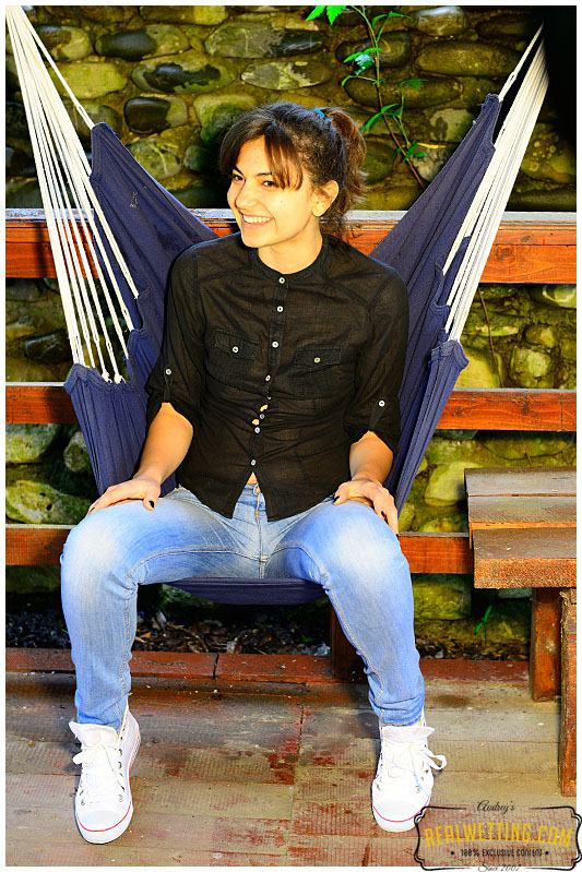 Sexy girl wetting her jeans sitting on hammock