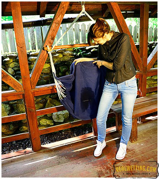 Sexy girl wetting her jeans sitting on hammock