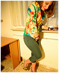 New model Gemma wets her green skin-tight capris waiting