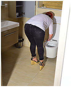 lady wearing tight black jeans wets herself while wiping toilet 0