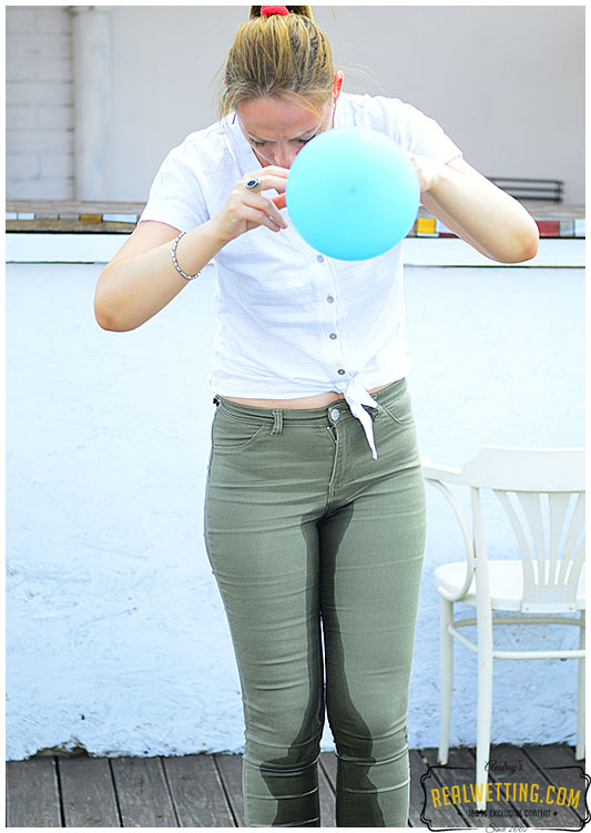 She blew too hard into the balloons as piss came out into her jeans