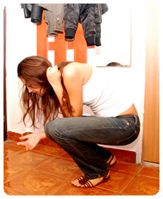 natalie is checking if the floor is clean so she could clean it with her pissing her jeans