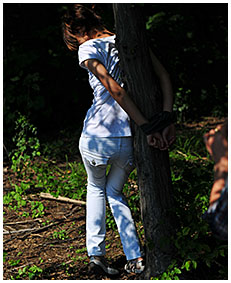 peeing in white jeans while she is tied to a tree 01