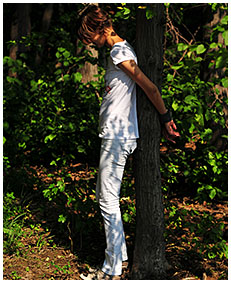 Bound to a tree Natalie wets her white jeans